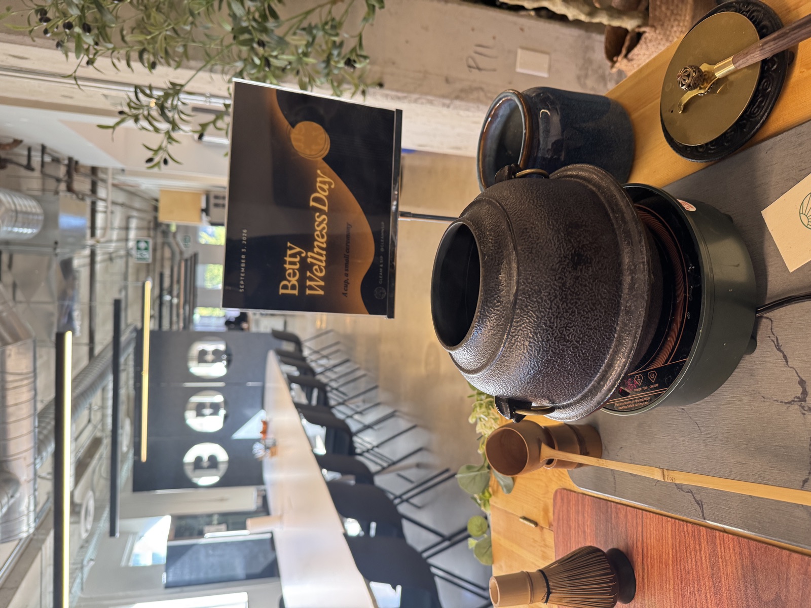 The tea ceremony station and Betty Wellness Day sign at the Toronto office on September 3, 2026