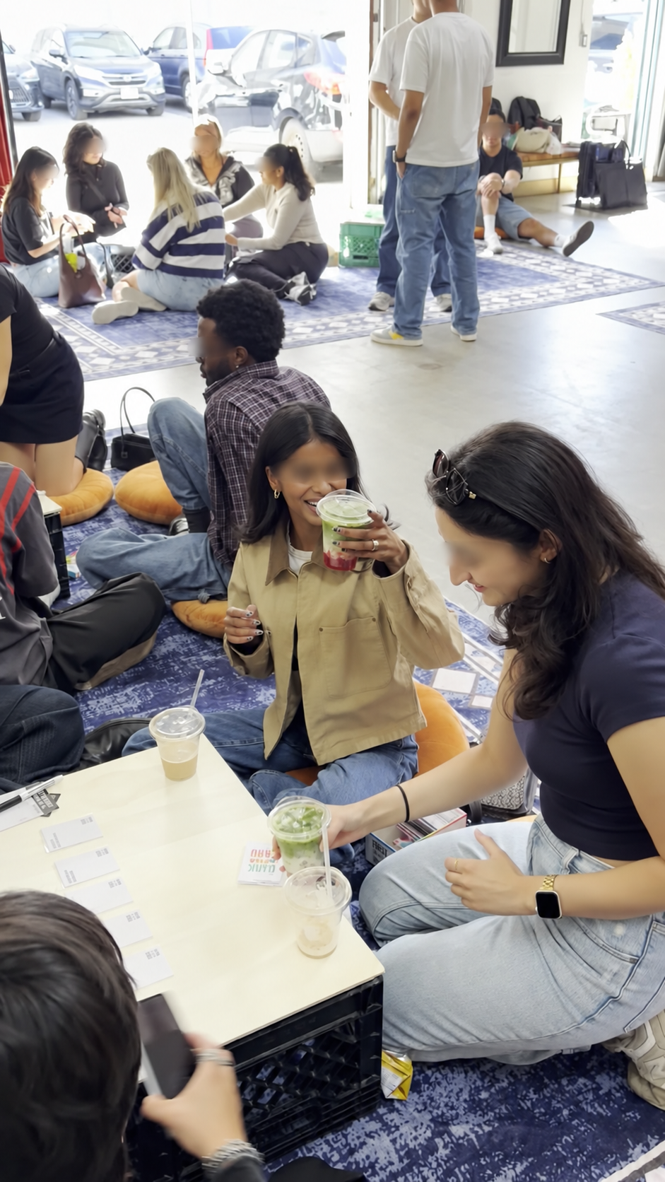 Guests smiling and holding strawberry matcha at General Admission
